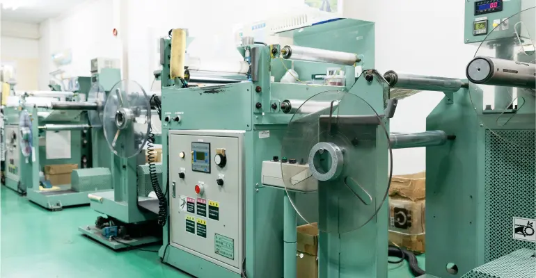 チューブ印刷後の品質を確認する巻き返し検査機と検査作業の様子